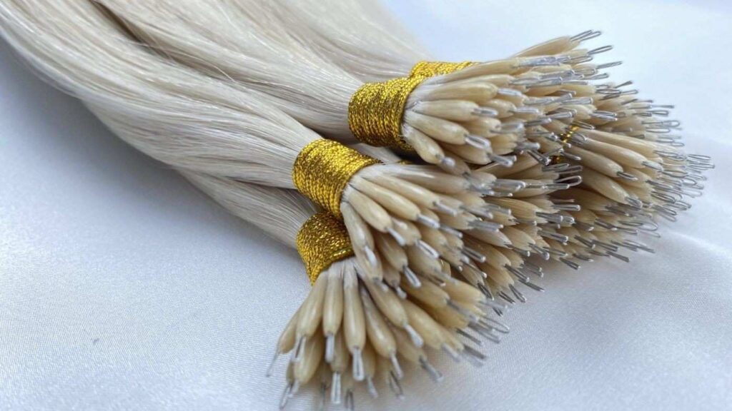 Micro-link hair extensions being installed strand by strand